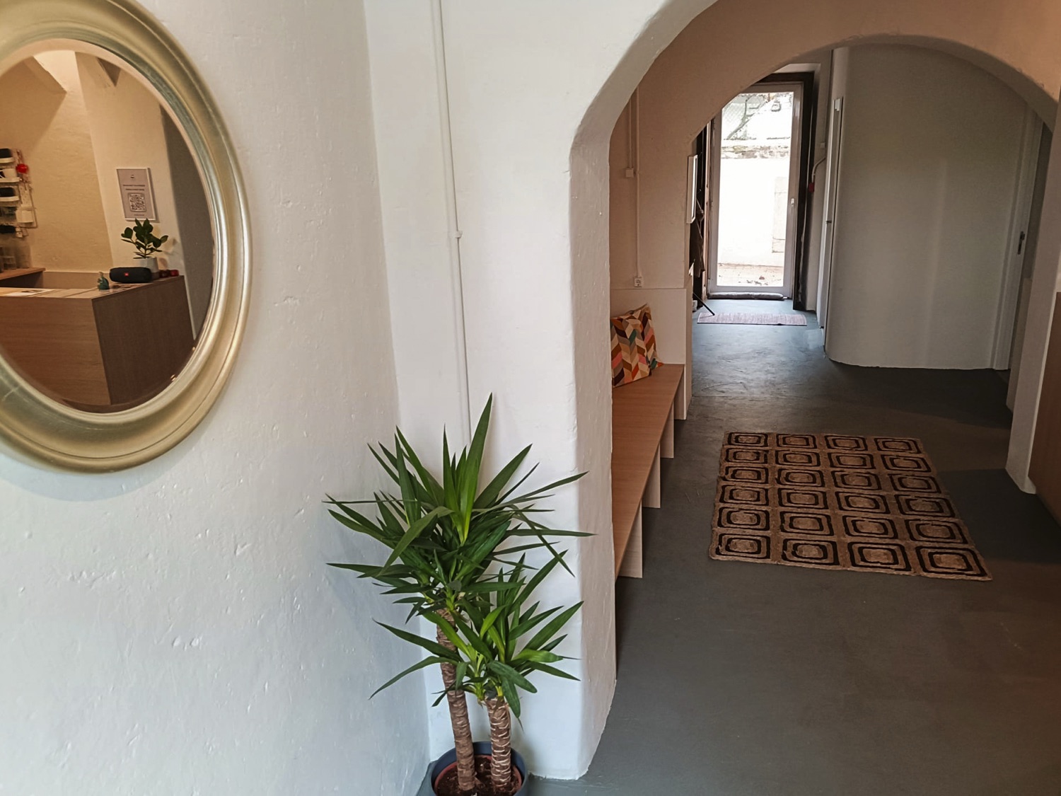 The hallway, with its round mirror and reception desk